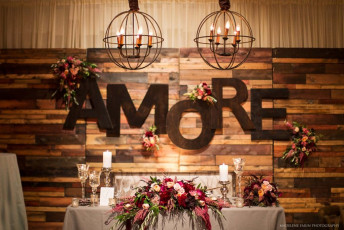 Reclaimed Wood Wall, Monogram Letters, and Iron Orb Chandeliers