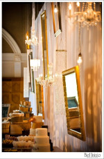 Heirloom Wall of Ivory Taffeta Drapery with Assorted Mirrors, Chandeliers, and Edison Bulbs