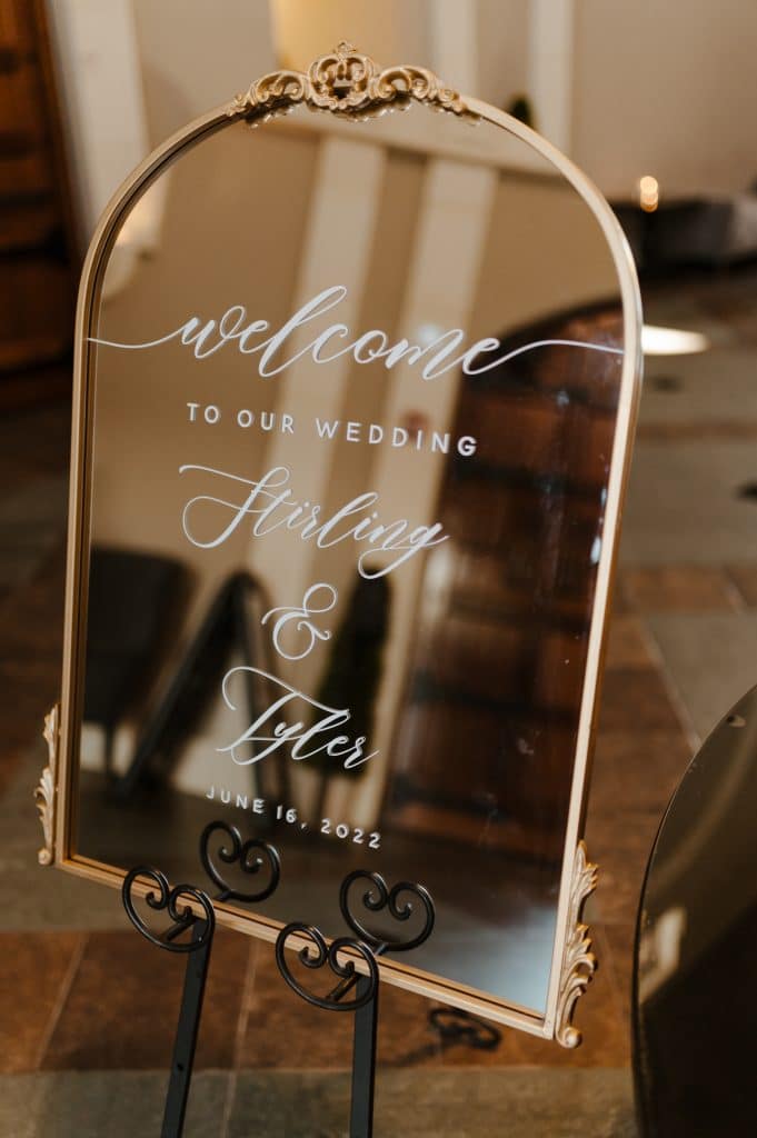 Gold mirror with calligraphy as a wedding welcome sign 