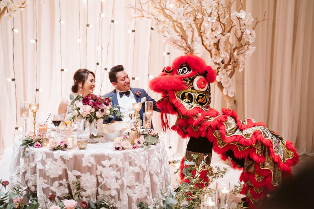 bride and groom with a dragon dancer